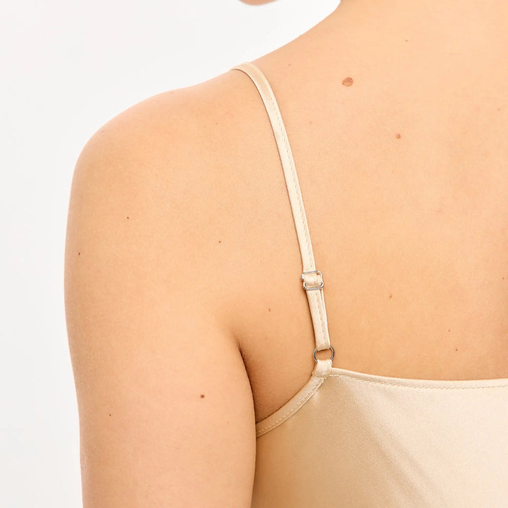 
                  
                    Beige slip dress with adjustable strap.
                  
                