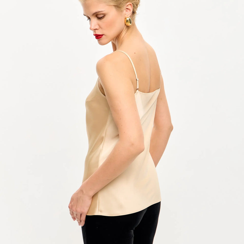 
                  
                    Sleeveless beige satin camisole.
                  
                