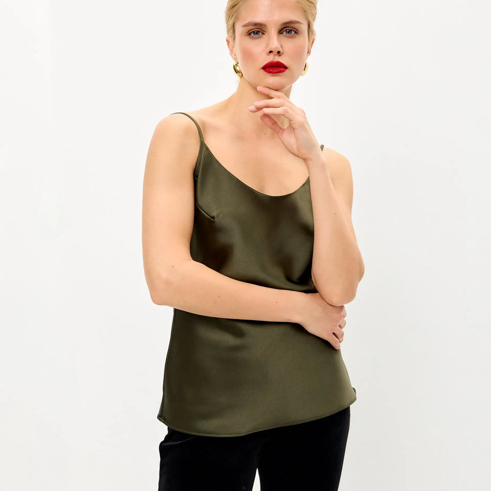 
                  
                    Woman in olive green silk camisole.
                  
                