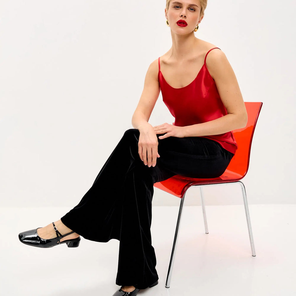 
                  
                    Woman in red top and black pants.
                  
                