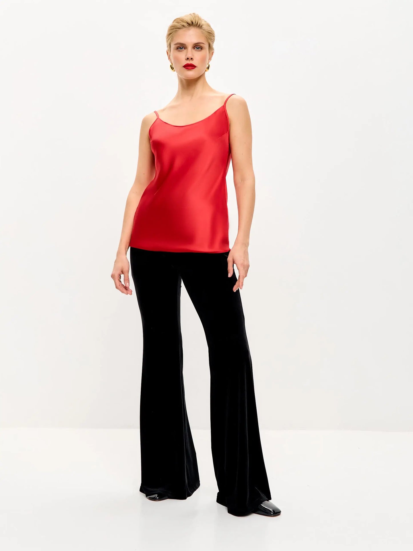 Woman in red top and black pants.